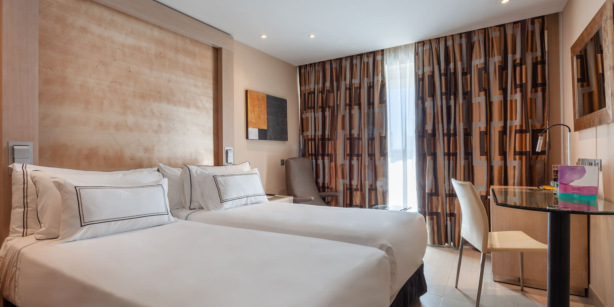 a room with two beds and a table