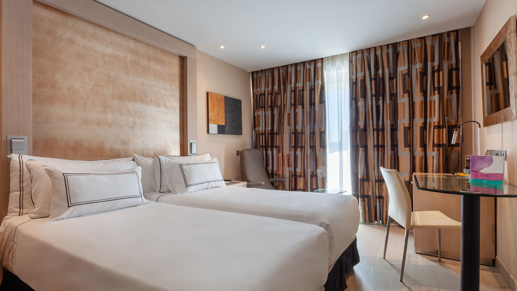 a room with two beds and a table