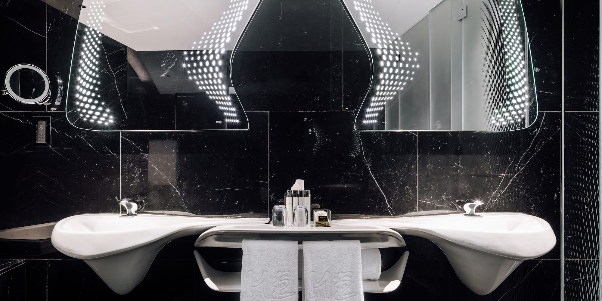 a bathroom with mirrors and sinks