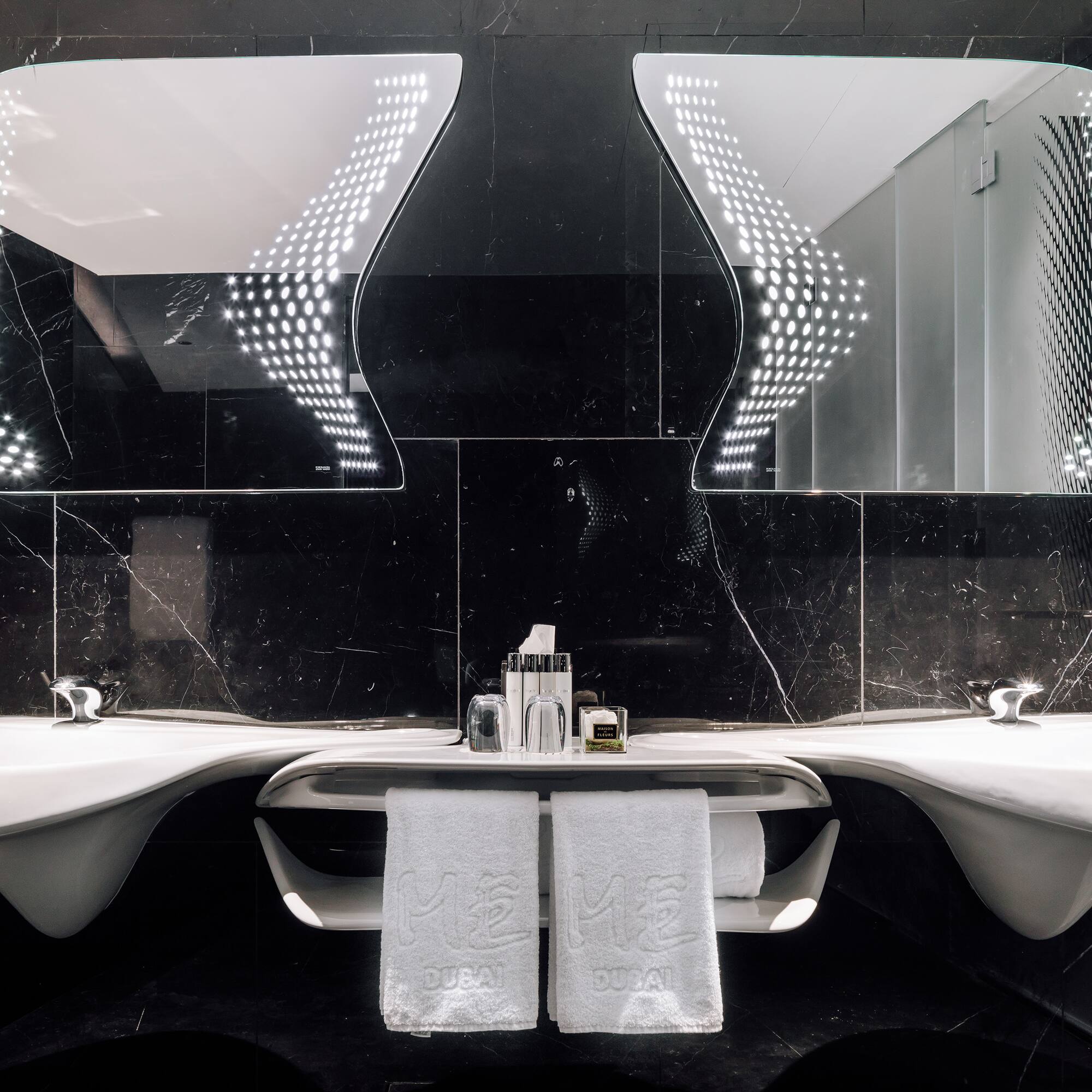 a bathroom with mirrors and sinks