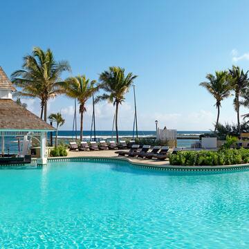a pool with lounge chairs and a gazebo