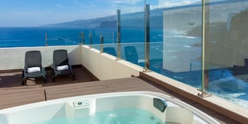 a hot tub overlooking the ocean