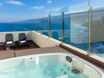 a hot tub overlooking the ocean