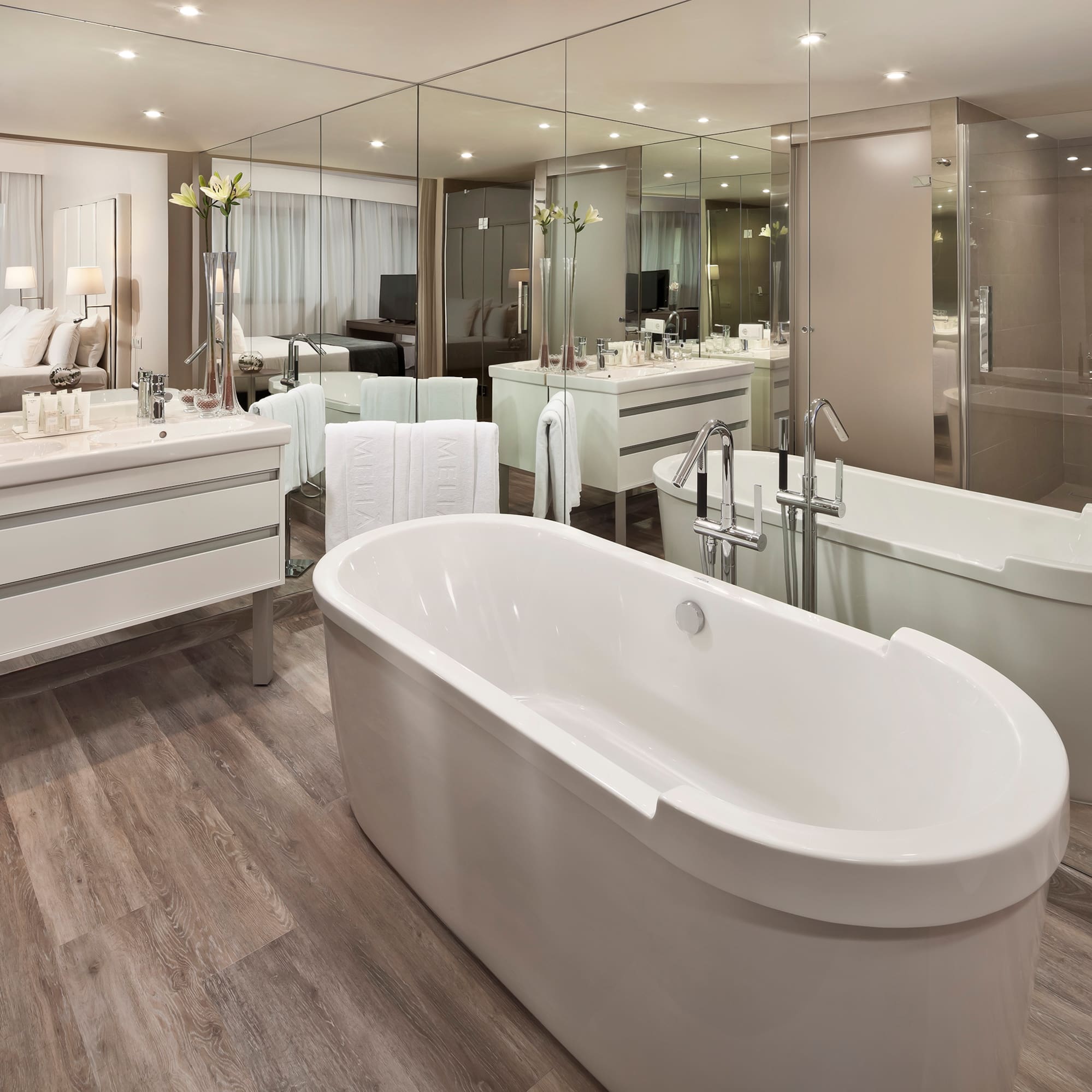 a bathroom with a large tub and a large mirror