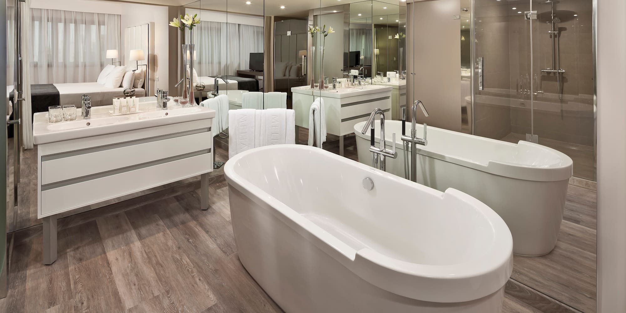 a bathroom with a large tub and a large mirror