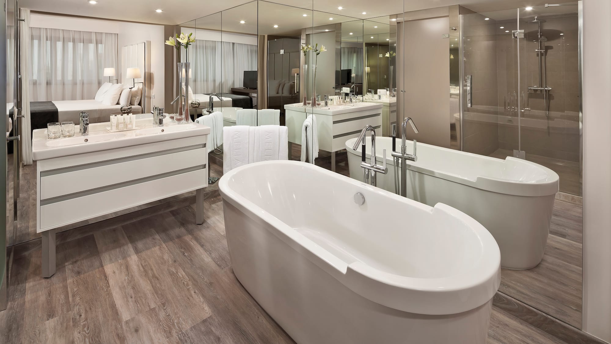 a bathroom with a large tub and a large mirror