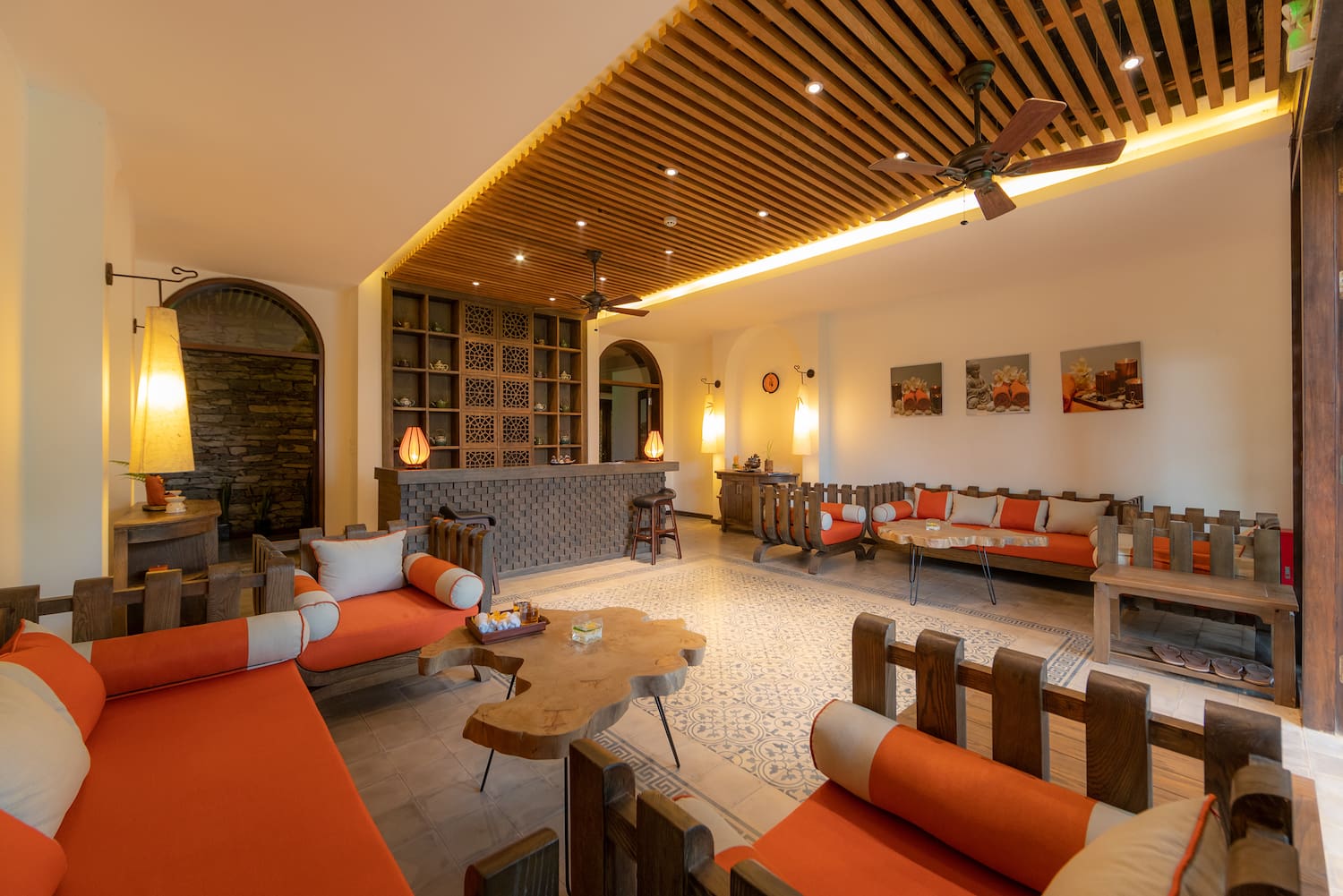 a room with orange couches and a table