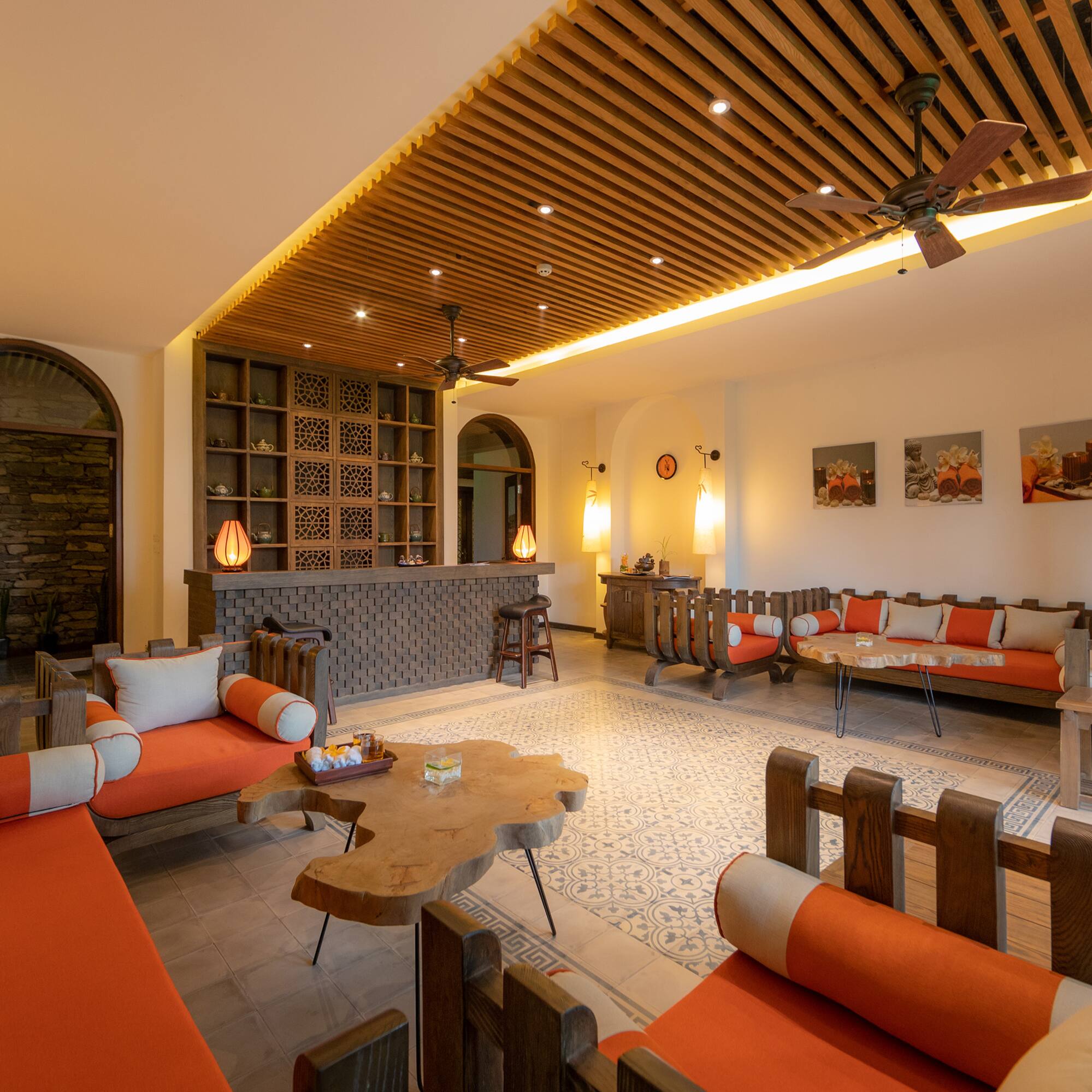 a room with orange couches and a table
