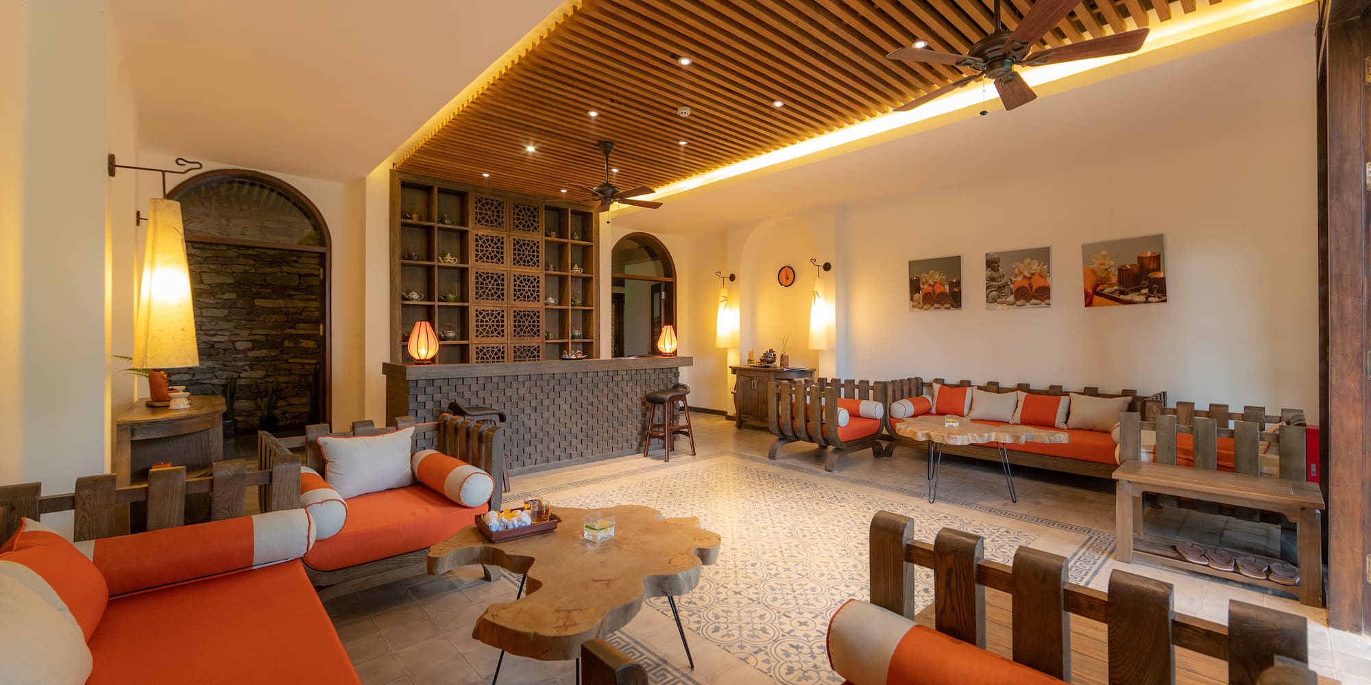 a room with orange couches and a table