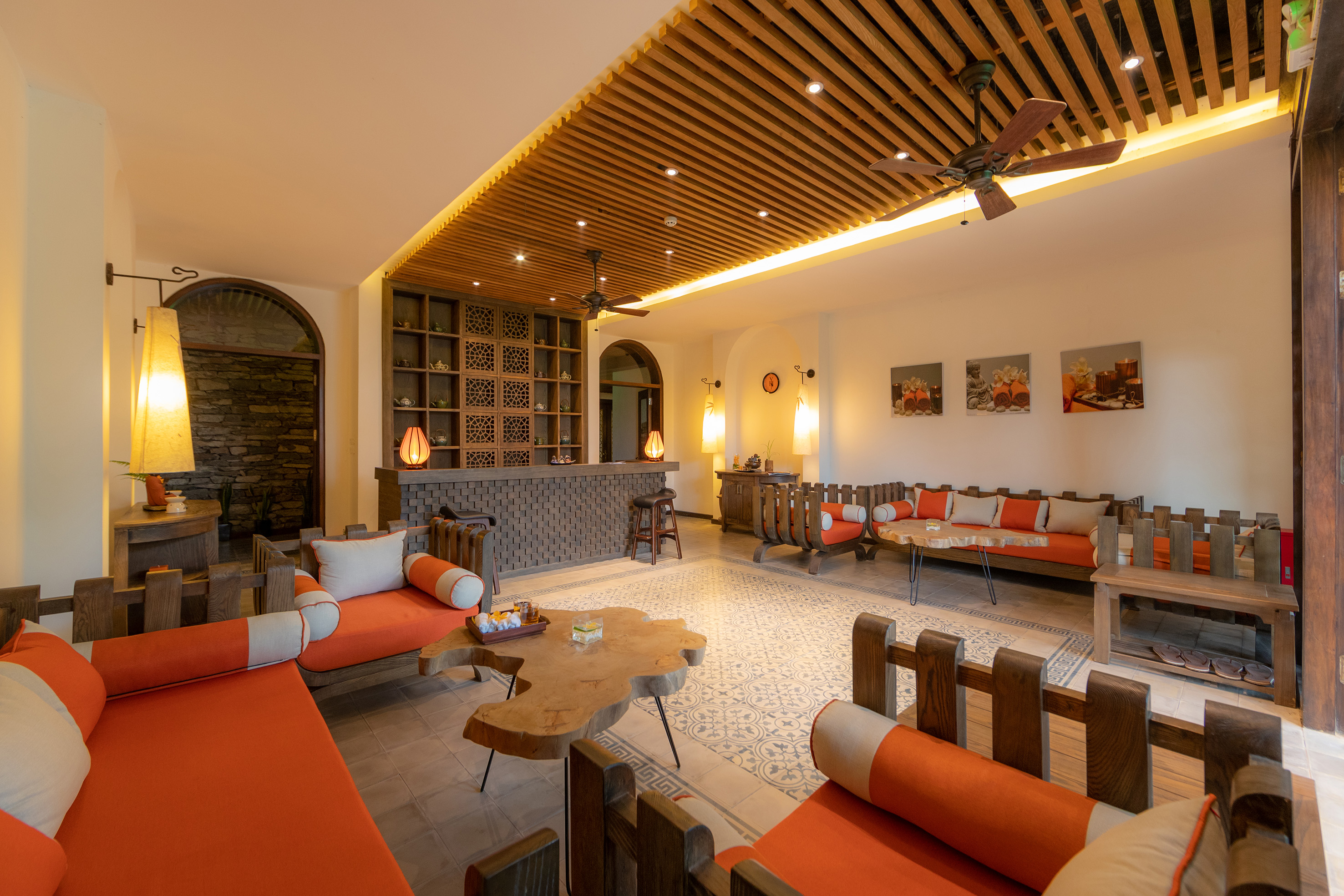 a room with orange couches and a table