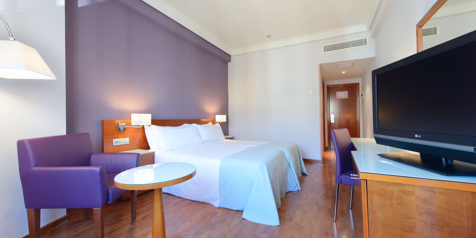 a room with a bed and purple walls