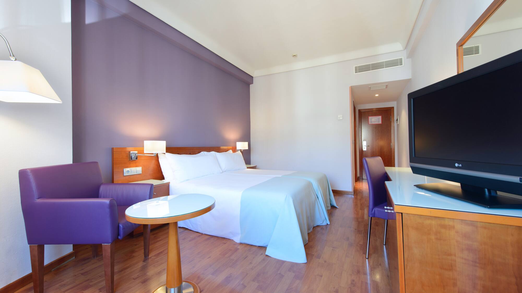 a room with a bed and purple walls