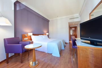 a room with a bed and purple walls