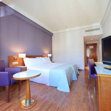 a room with a bed and purple walls