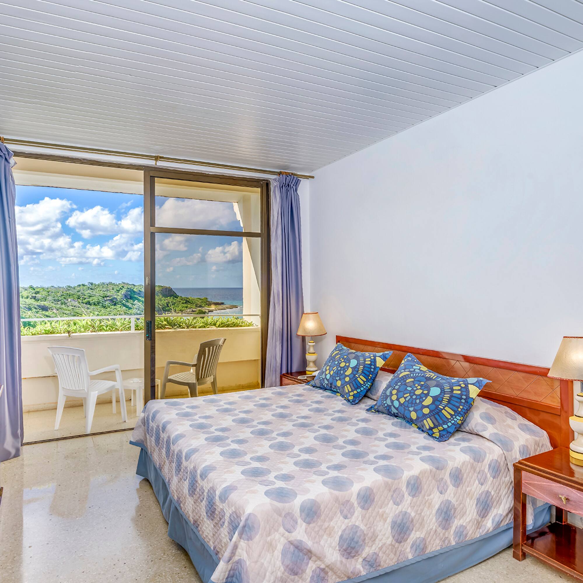 a bedroom with a bed and a balcony