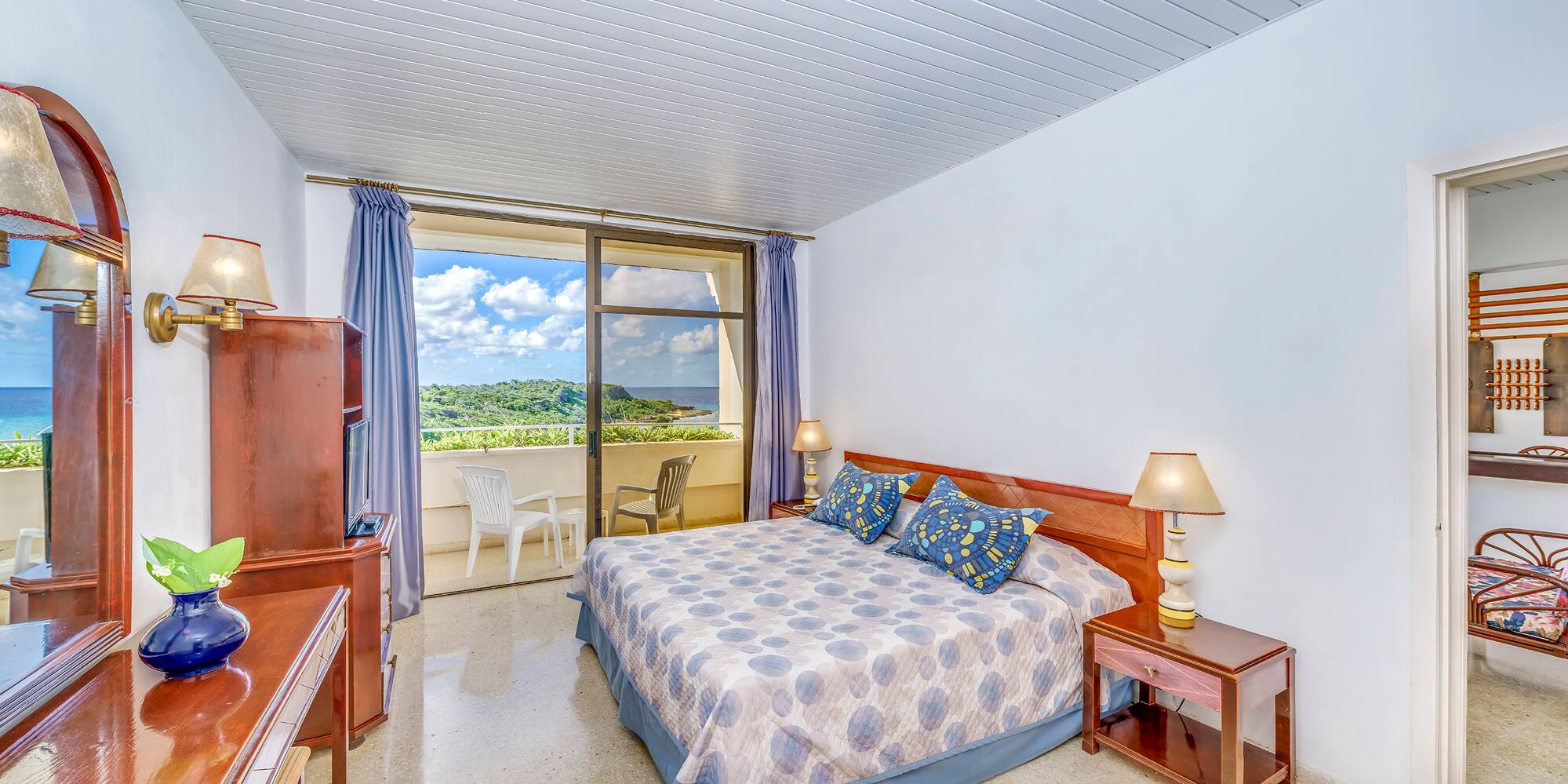 a bedroom with a bed and a balcony