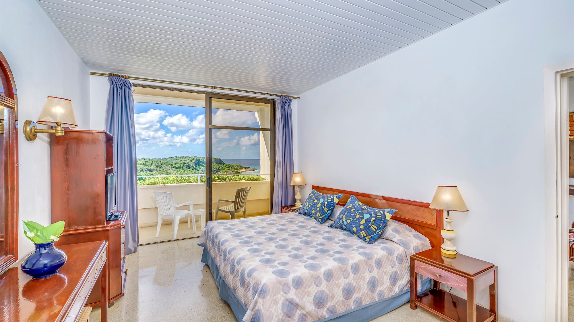 a bedroom with a bed and a balcony