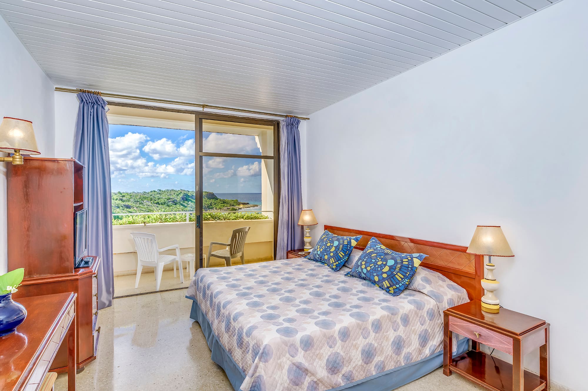 a bedroom with a bed and a balcony