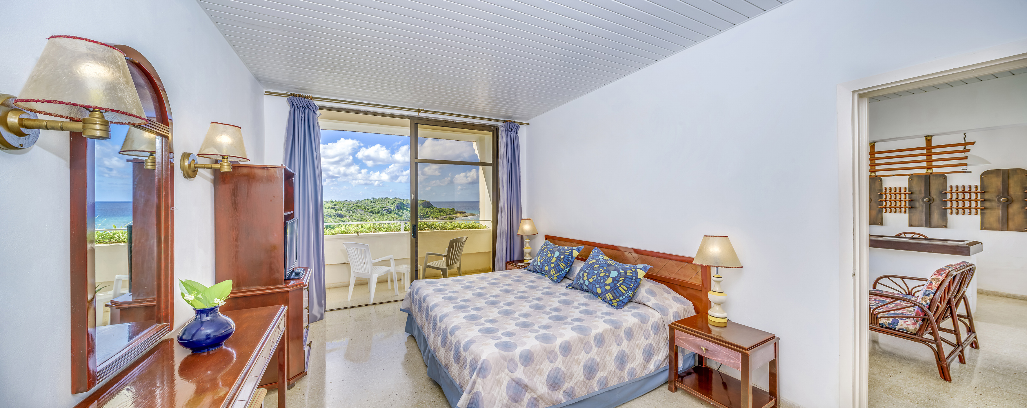 a bedroom with a bed and a balcony