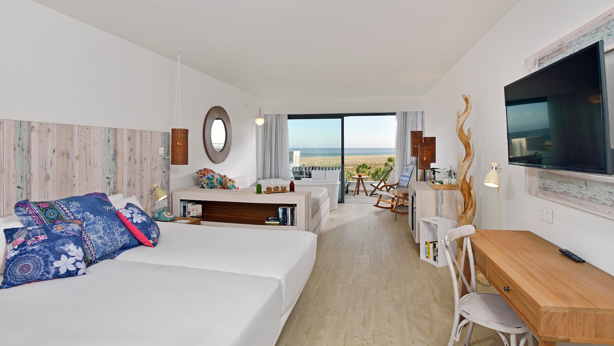 a room with two beds and a large window