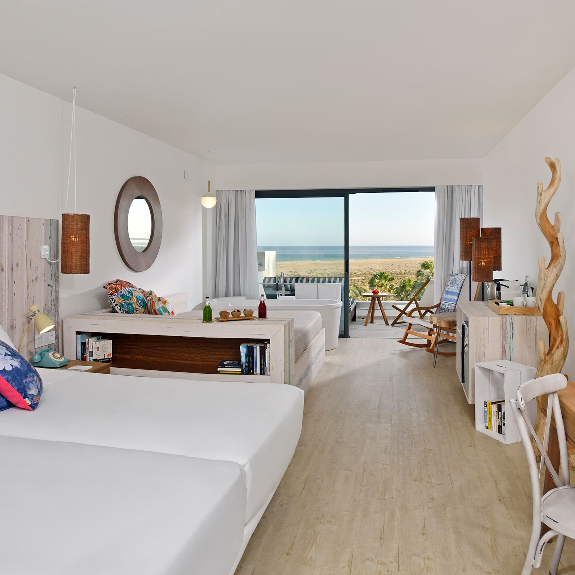 a room with two beds and a large window