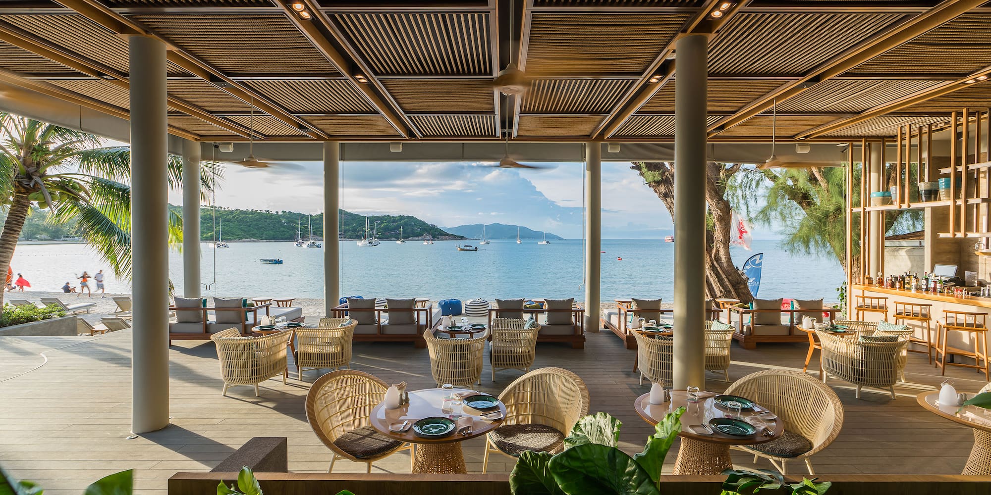 a restaurant with tables and chairs and a view of the water