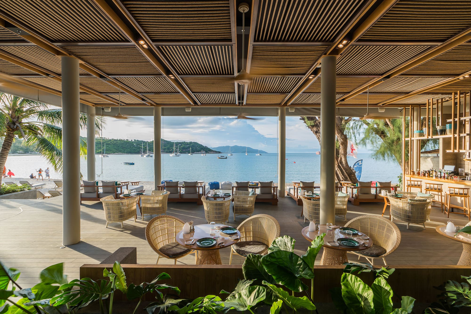 a restaurant with tables and chairs and a view of the water