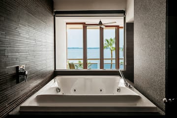 a bathtub with a window overlooking the ocean