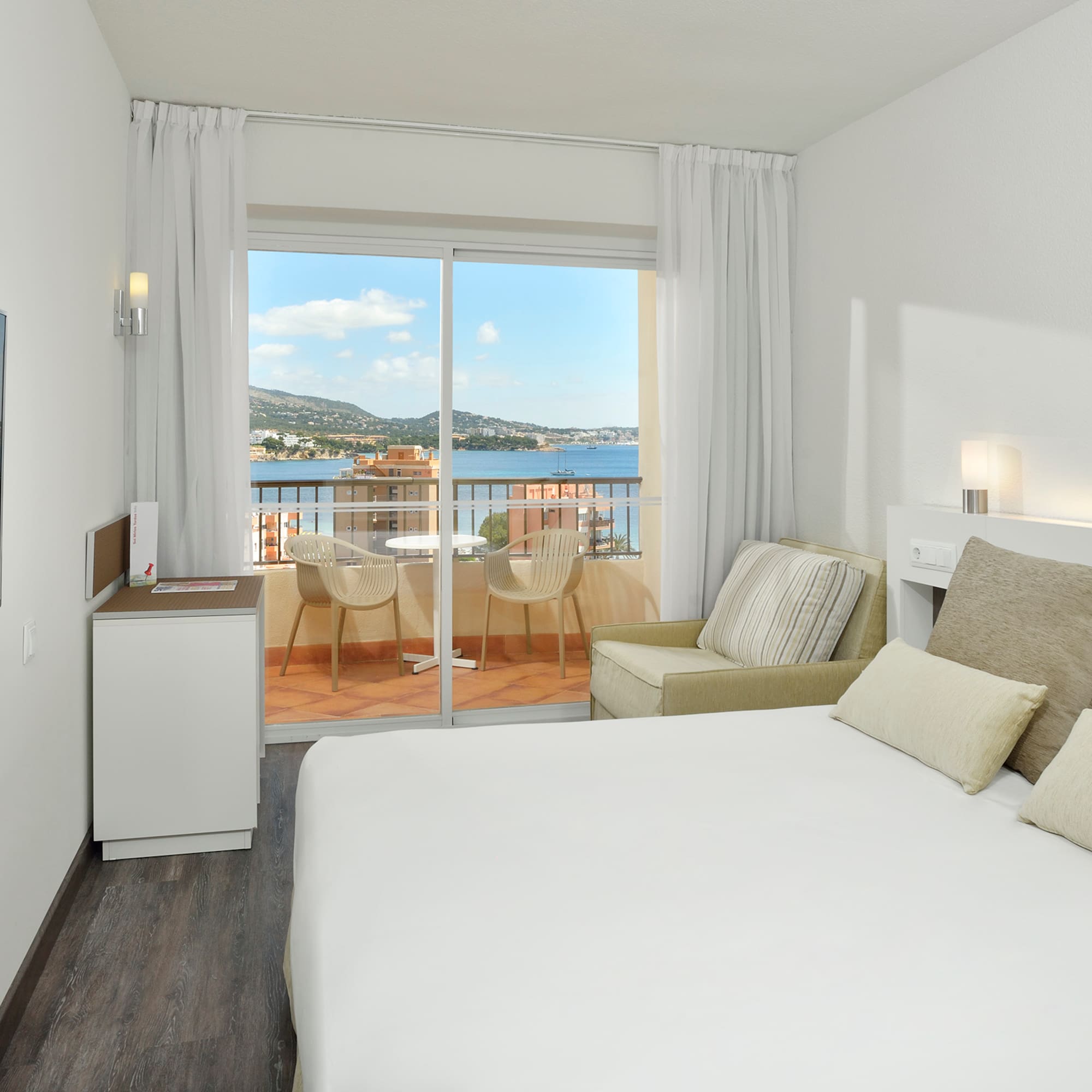 a room with a bed and a glass door