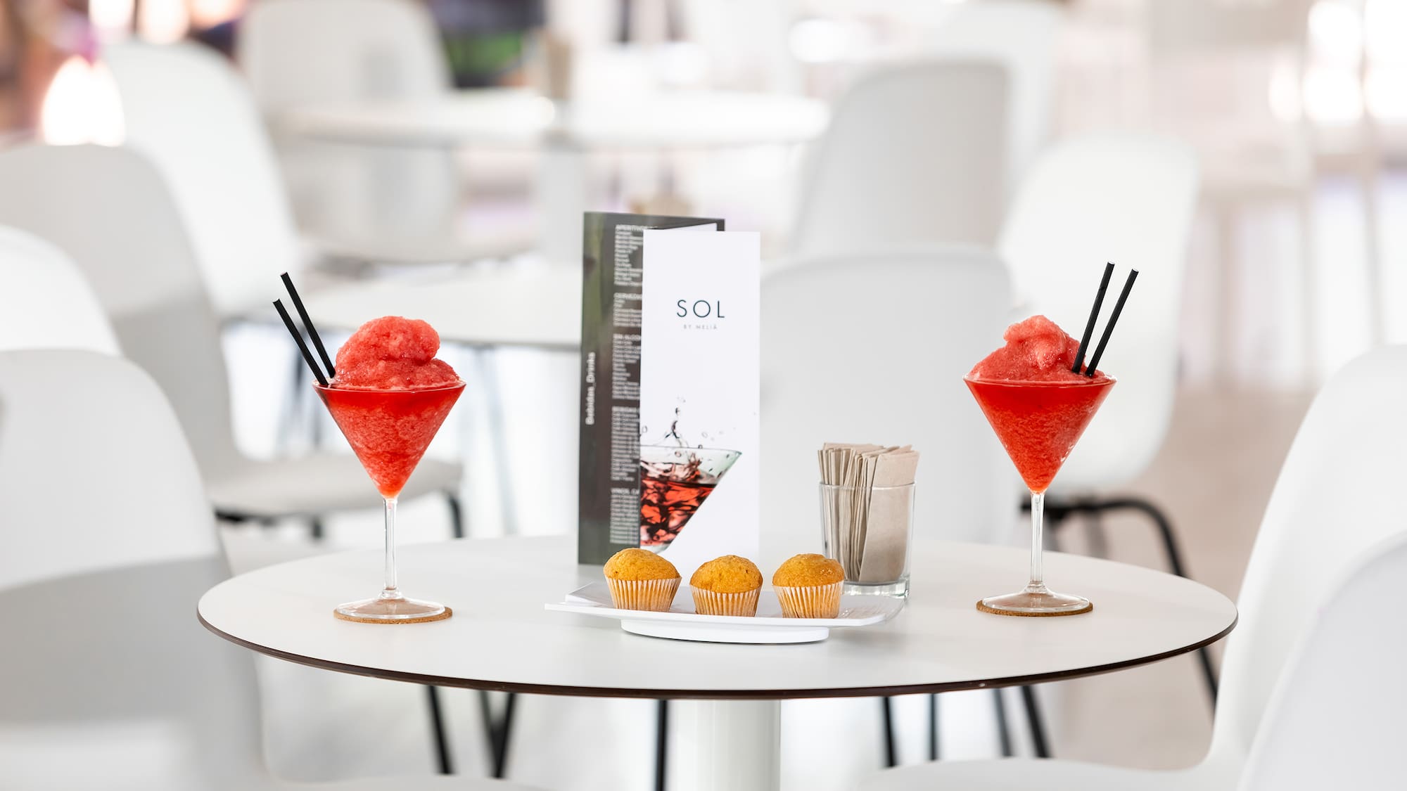 a table with drinks and muffins