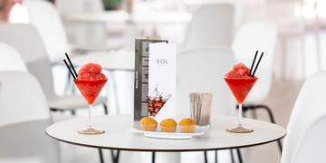 a table with drinks and muffins