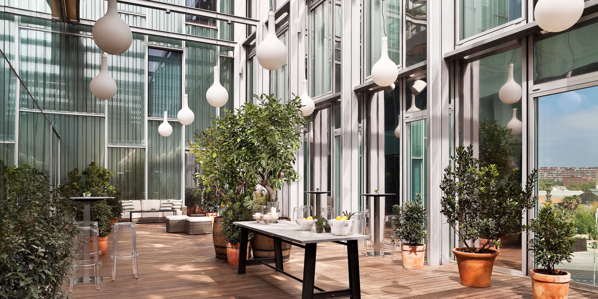 a patio with a table and potted plants