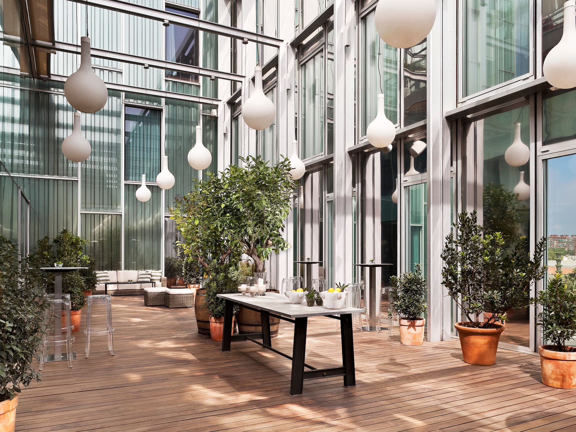 a patio with a table and potted plants