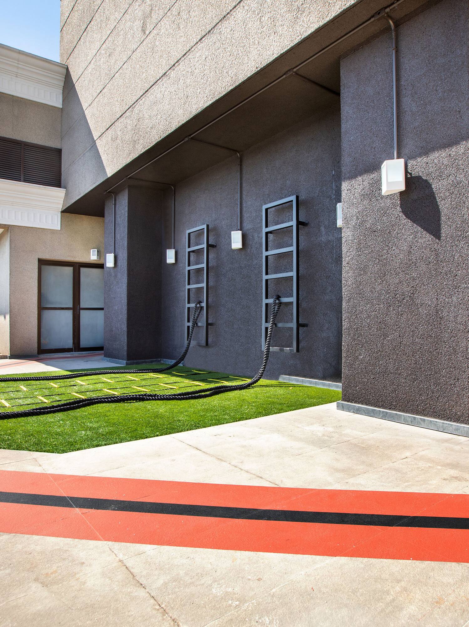 a building with a lawn and a hose attached to it