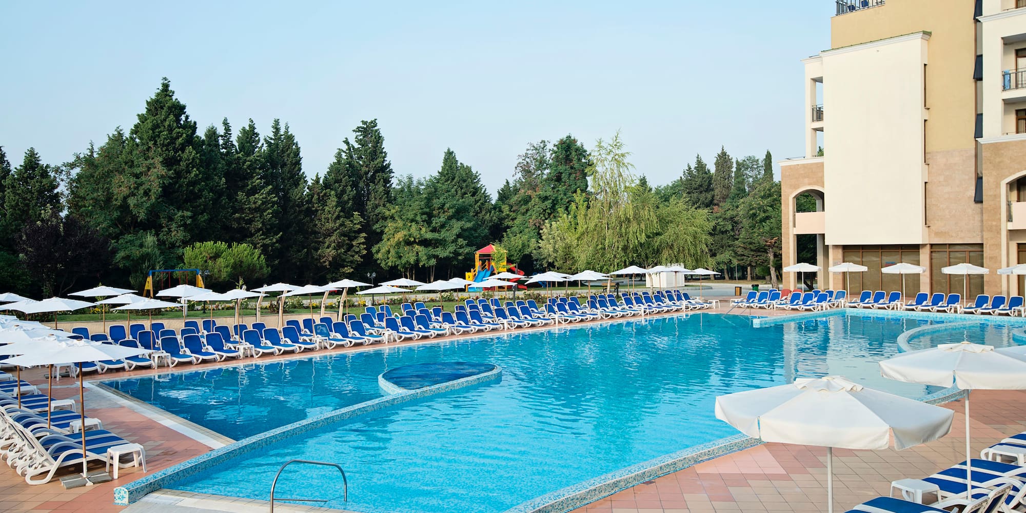 a pool with chairs and umbrellas