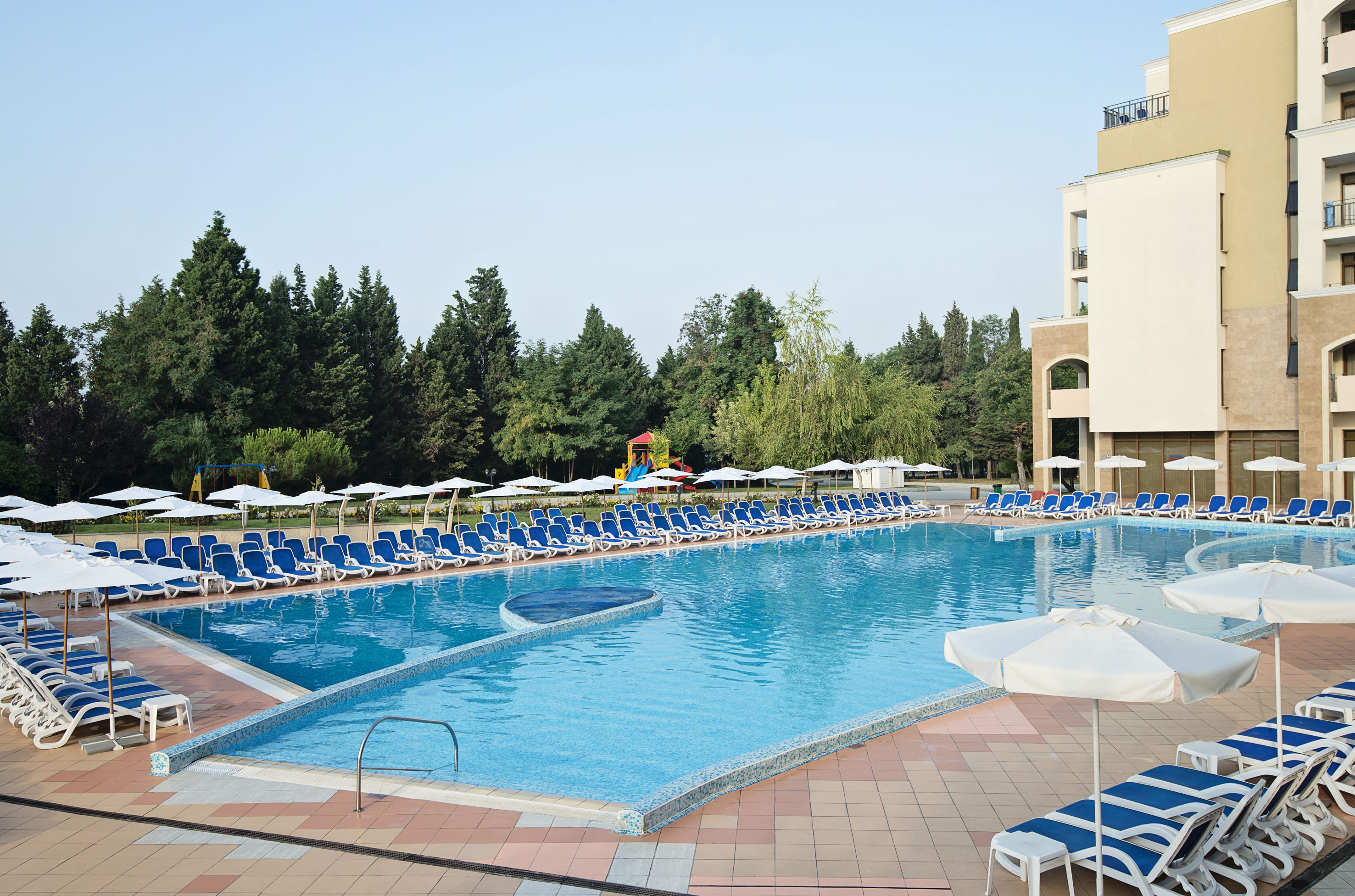 a pool with chairs and umbrellas