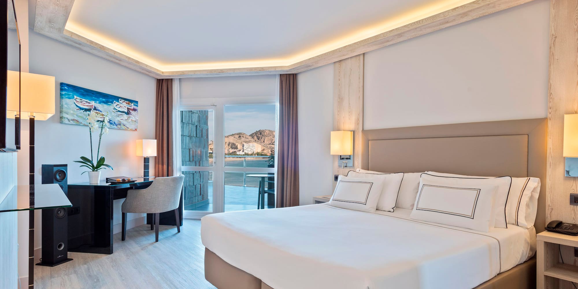 a bedroom with a bed and a desk and chair