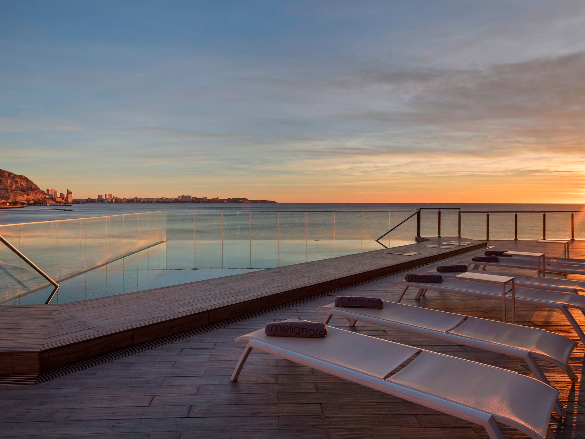 a pool with a body of water and chairs