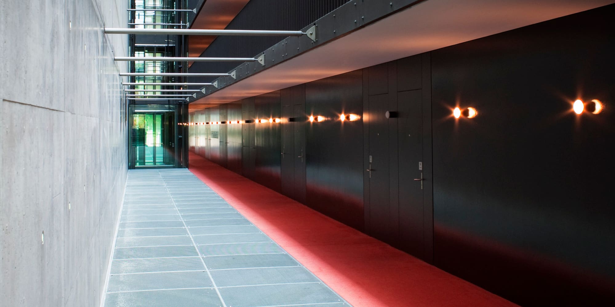 a hallway with red carpet and doors