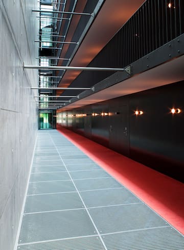 a hallway with red carpet and doors