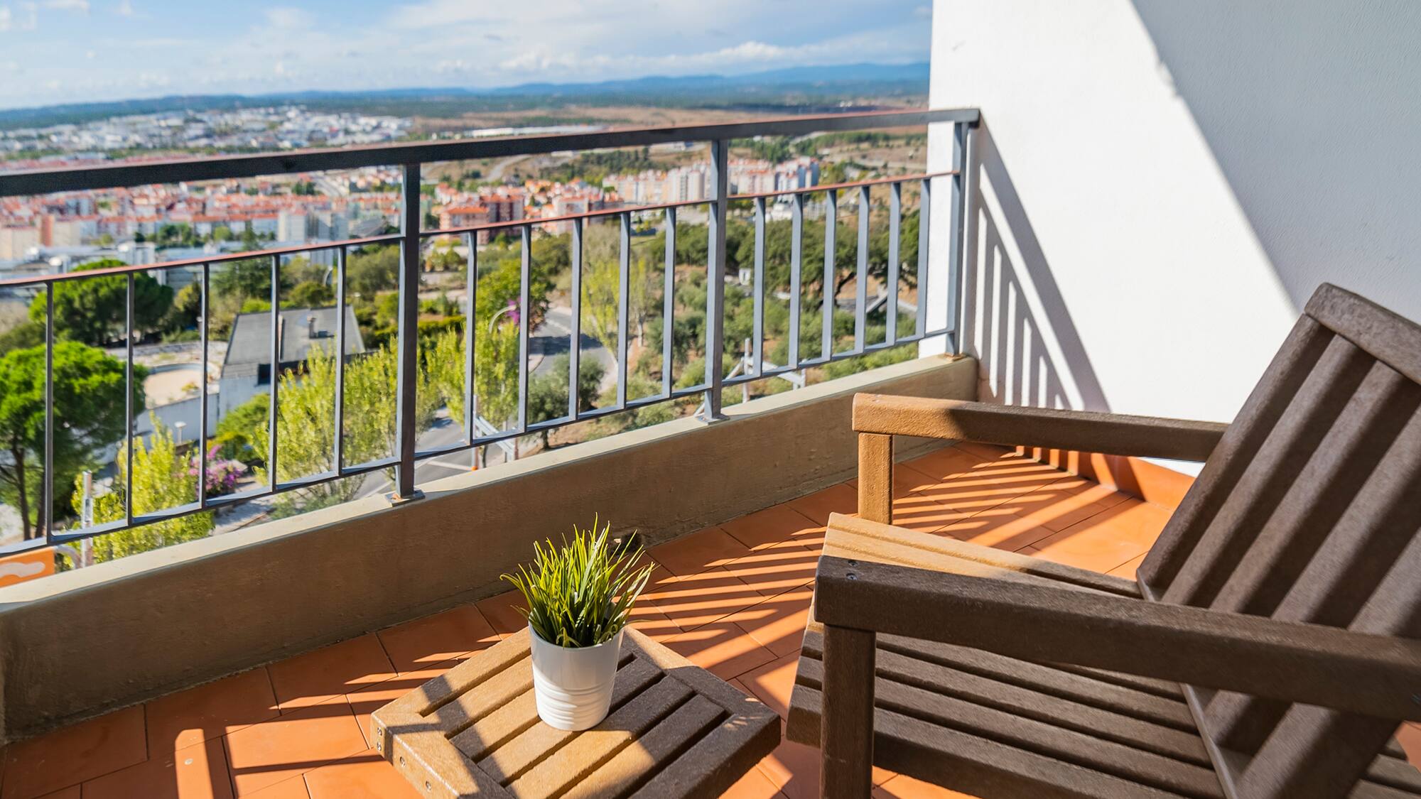a chair and table on a balcony