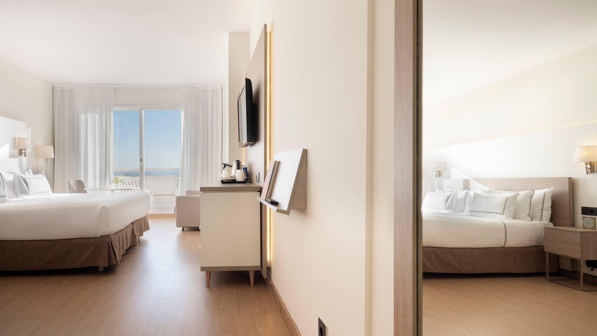 a room with a bed and a television