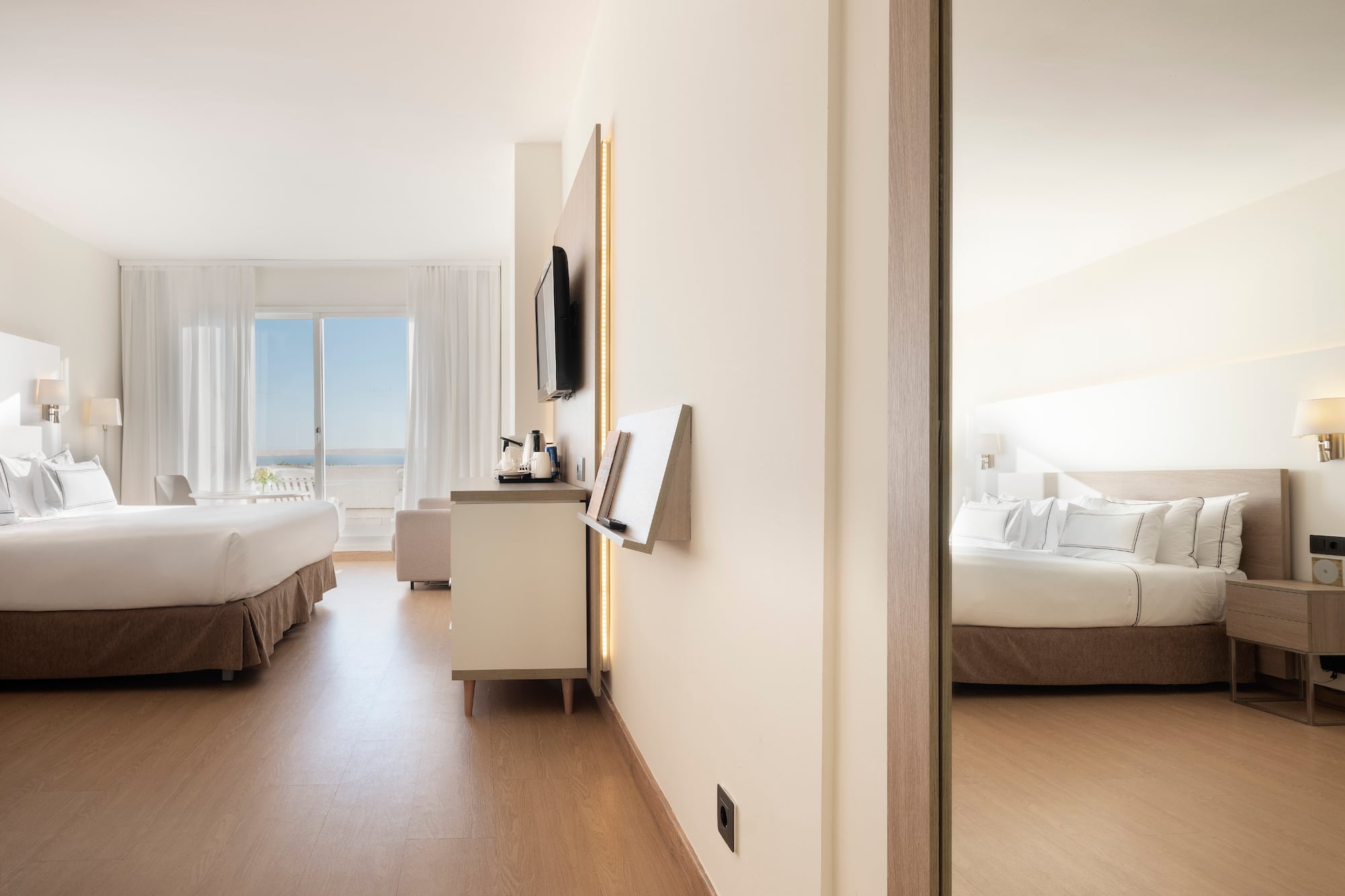 a room with a bed and a television