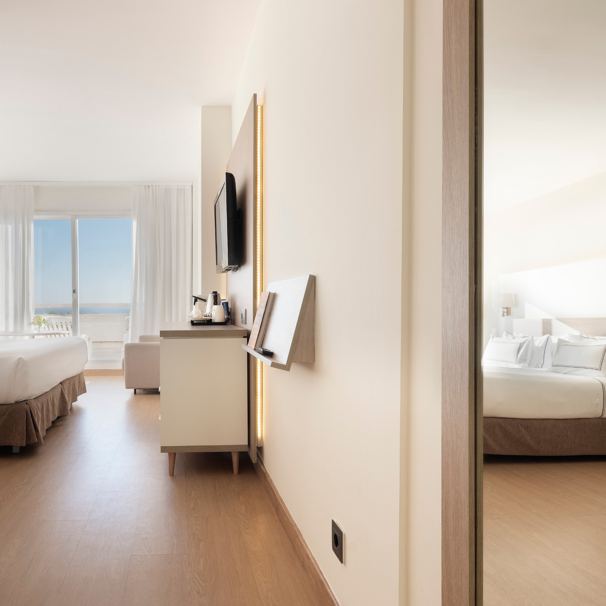 a room with a bed and a television