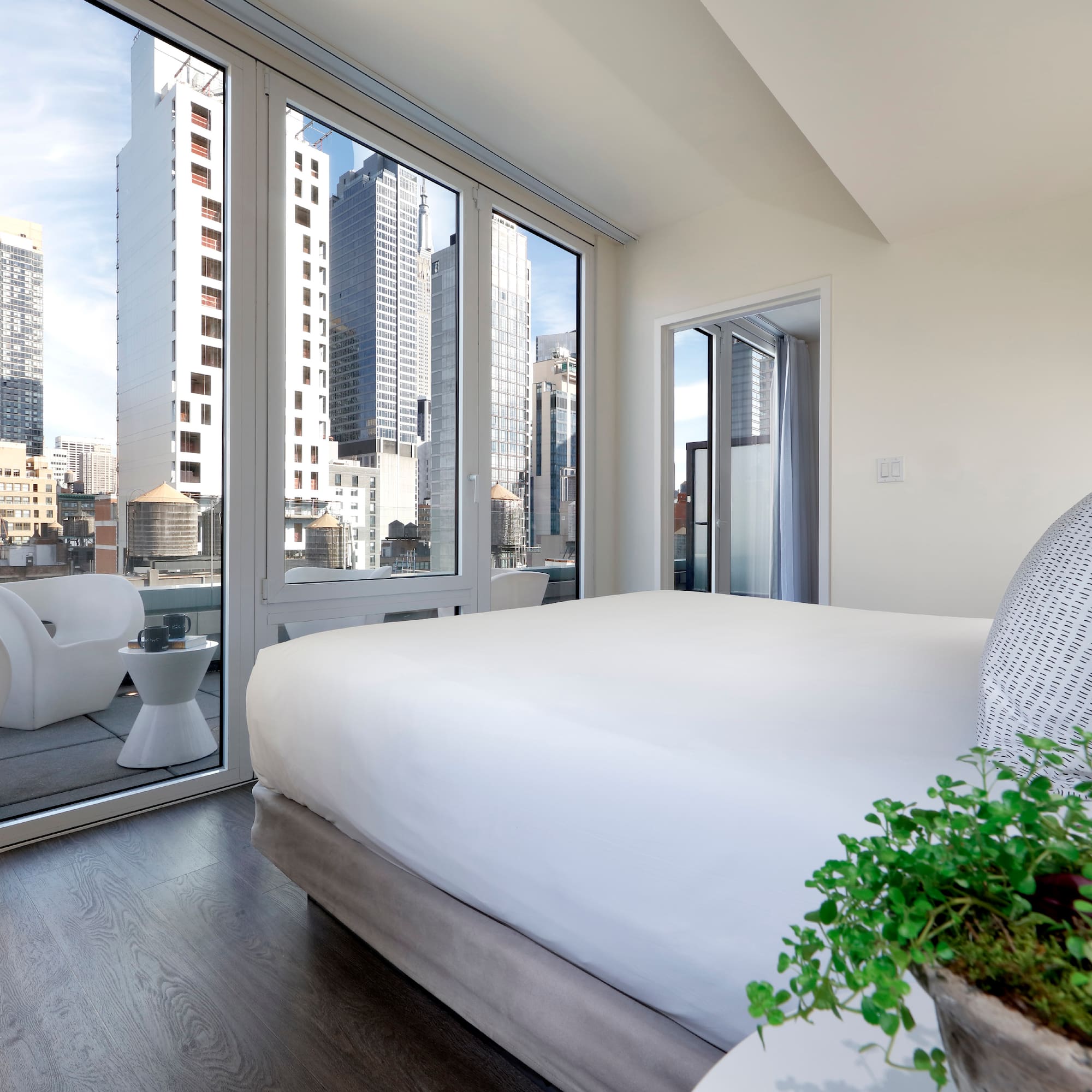 a bedroom with a view of a city