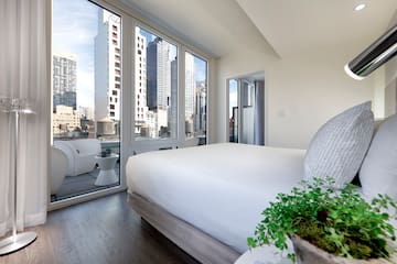 a bedroom with a view of a city