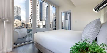 a bedroom with a view of a city