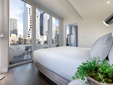a bedroom with a view of a city