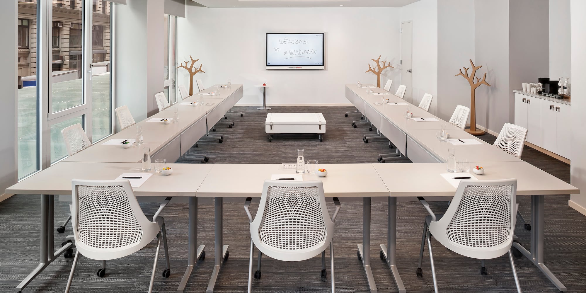 a room with white tables and chairs