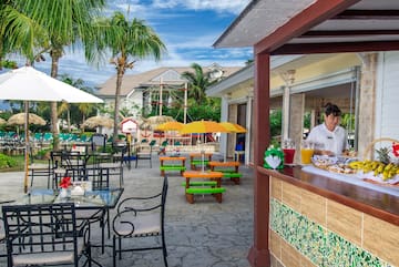 a woman sitting at a table outside of a restaurant
